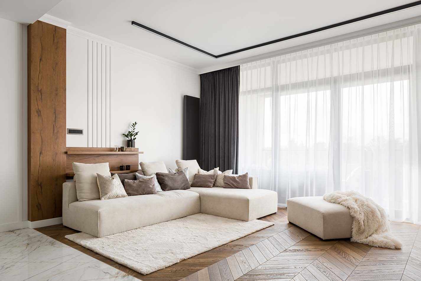 Living room with sofa, rug, and beautiful curtains